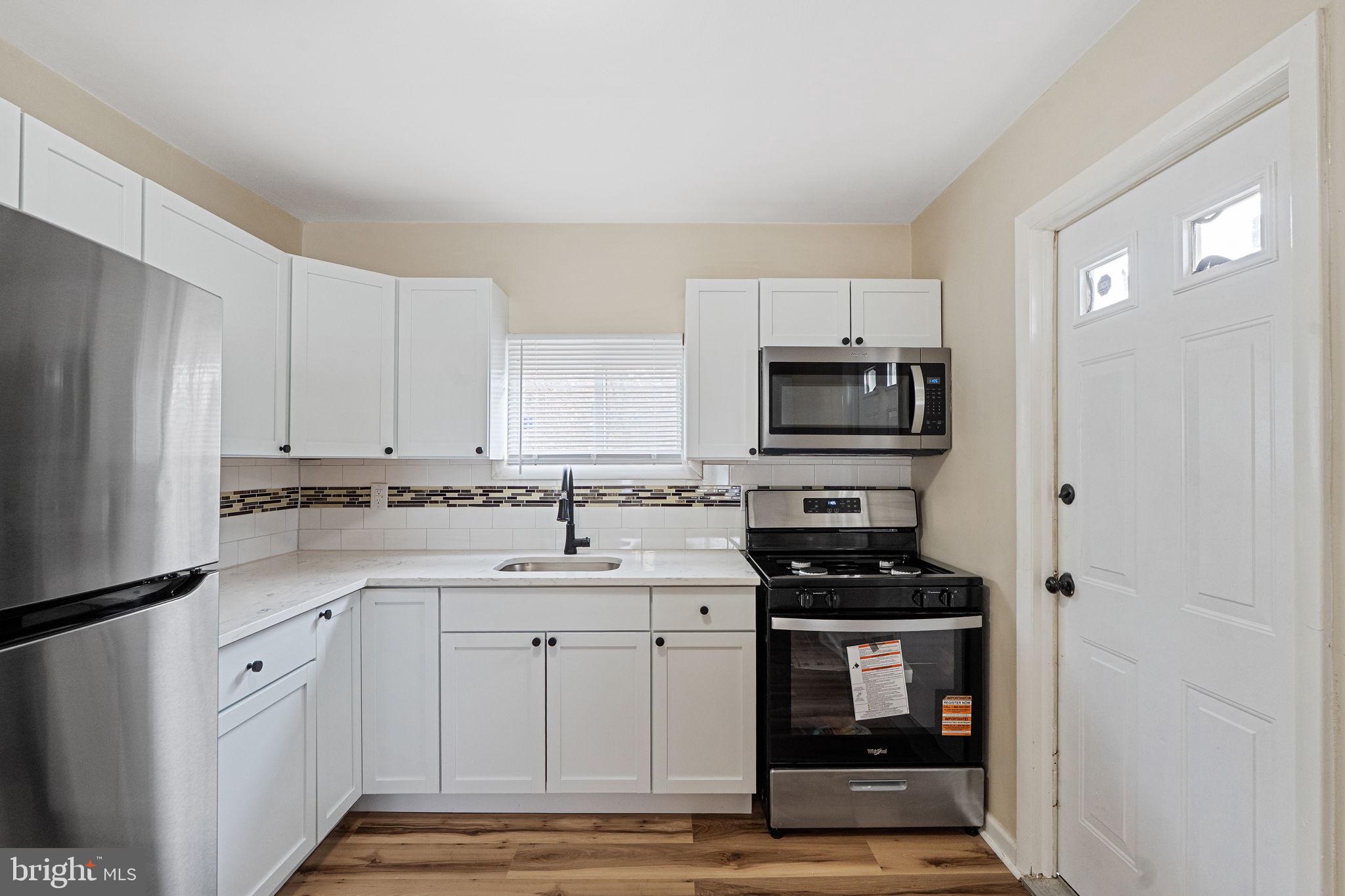 40 Wilson Road Clementon, NJ 08021 - Photo 11 of 31 a kitchen with stainless steel appliances a stove sink and microwave