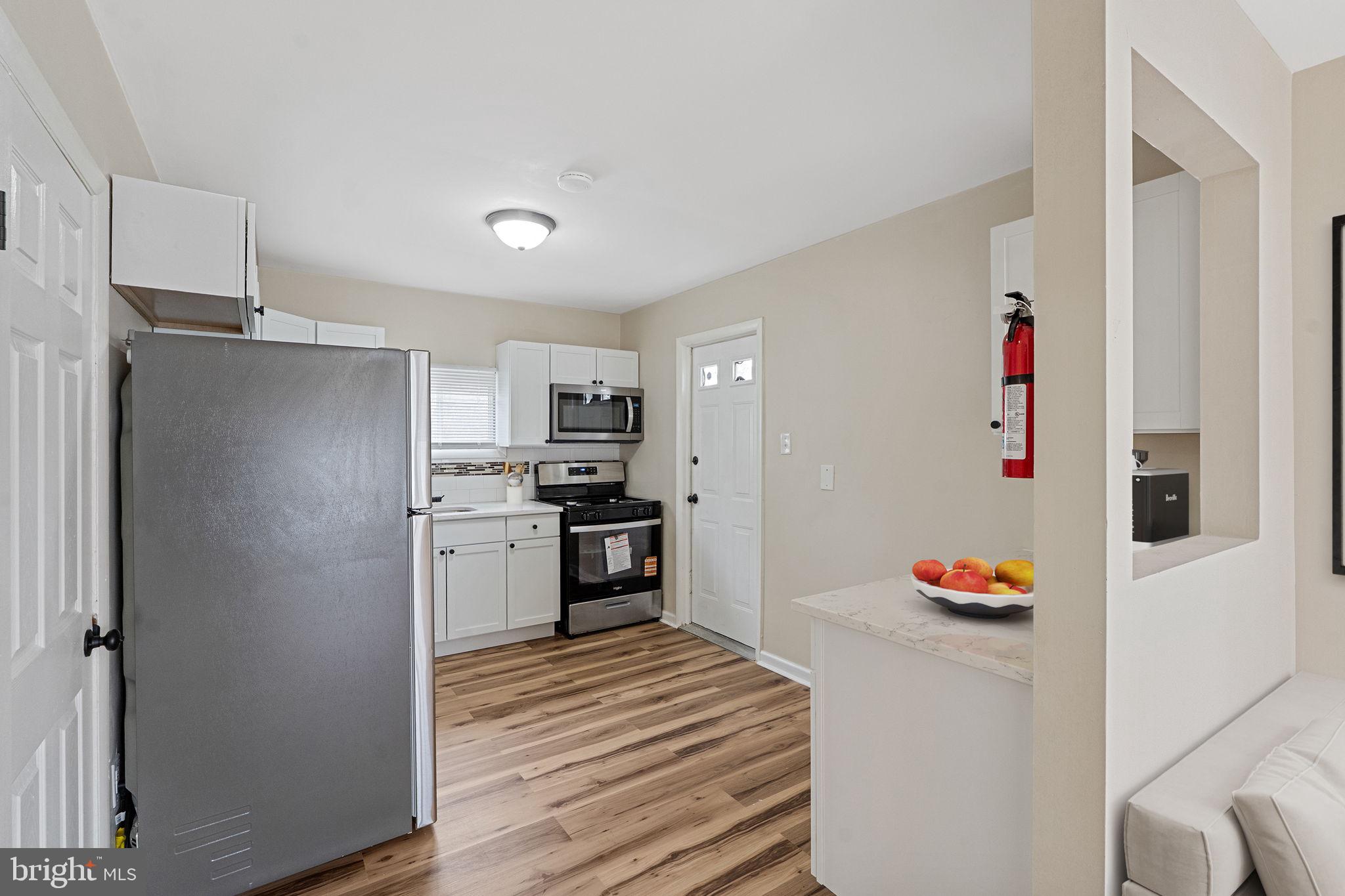 40 Wilson Road Clementon, NJ 08021 - Photo 12 of 31 a kitchen with stainless steel appliances kitchen island granite countertop a refrigerator and a sink