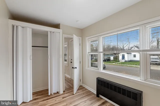 a view of room with window and wooden floor