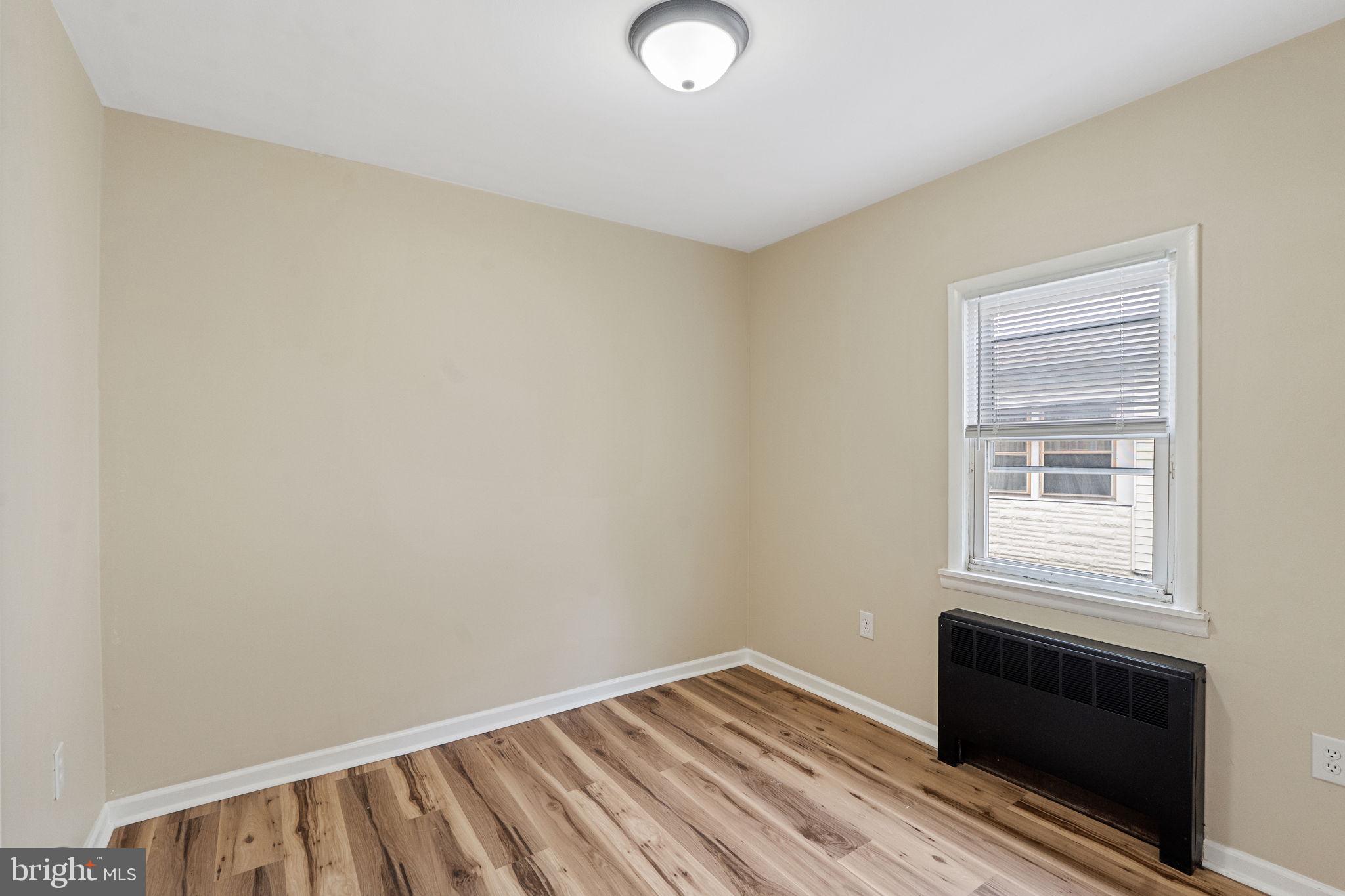 40 Wilson Road Clementon, NJ 08021 - Photo 22 of 31 a view of an empty room with wooden floor and a window