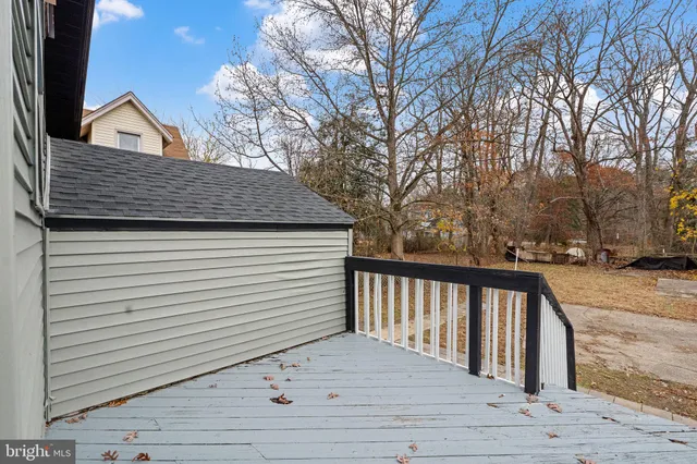 a view of a wooden balcony and trees