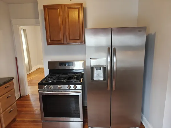 a stove top oven sitting inside of a kitchen