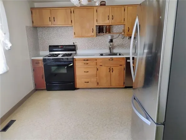 a kitchen with a stove and a refrigerator