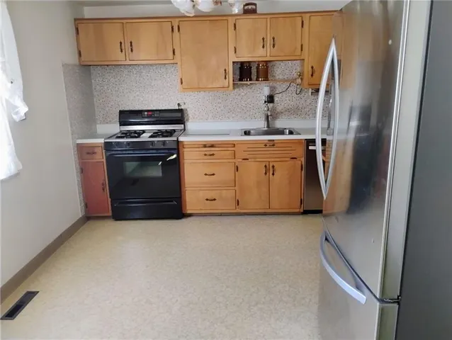 a kitchen with a stove and a refrigerator