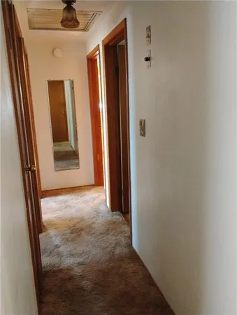 a view of an empty room with a closet
