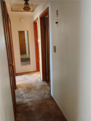 a view of an empty room with a closet