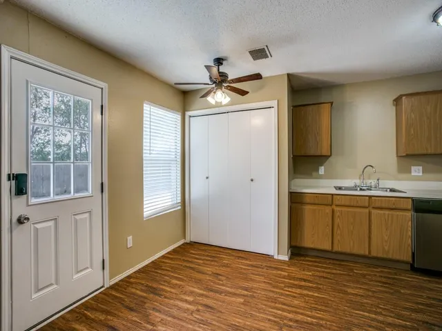 a bathroom with a granite countertop sink a mirror and a shower