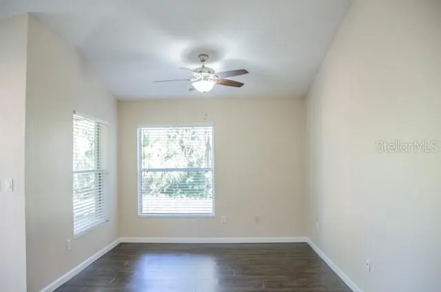 a view of room with a ceiling fan and window