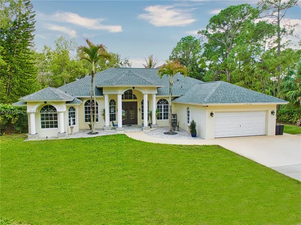 a front view of a house with a yard porch and sitting area