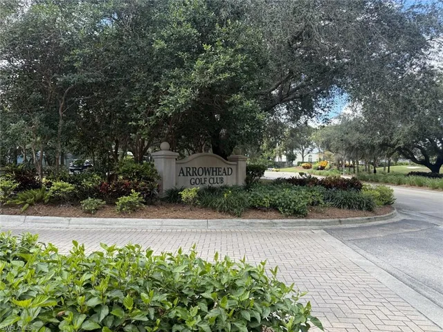 a dining room with furniture a chandelier and wooden floor