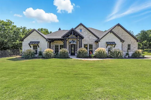 a front view of house with yard and green space