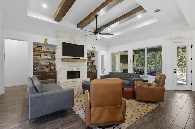 a living room with furniture a flat screen tv and a fireplace