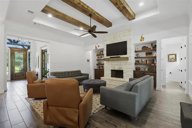a living room with furniture a flat screen tv and a fireplace