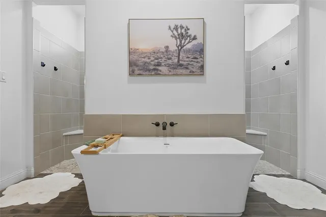a large bathroom with a sink mirror and a bath tub