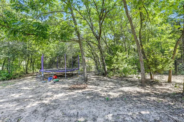a living room with furniture a fireplace and a floor to ceiling window
