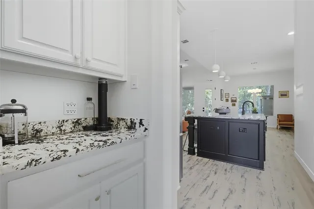 a bathroom with a sink and cabinets