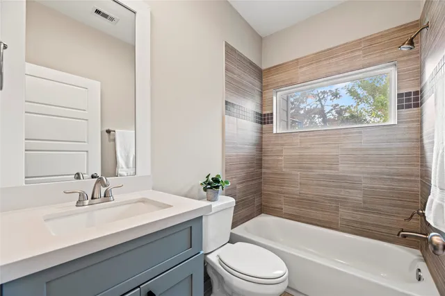 a bathroom with a sink a toilet and bathtub