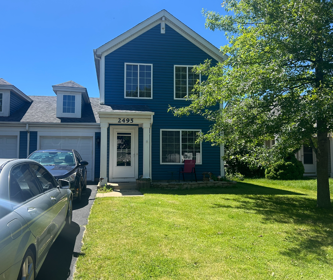 2495 Roxbury Lane Montgomery, IL 60538 - Photo 1 of 9 a front view of a house with garden