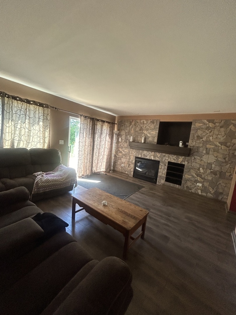 2495 Roxbury Lane Montgomery, IL 60538 - Photo 4 of 9 a living room with furniture and a flat screen tv