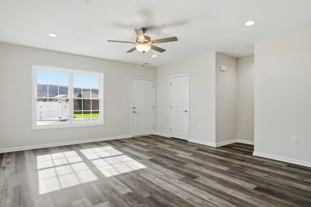 wooden floor in an empty room with a window