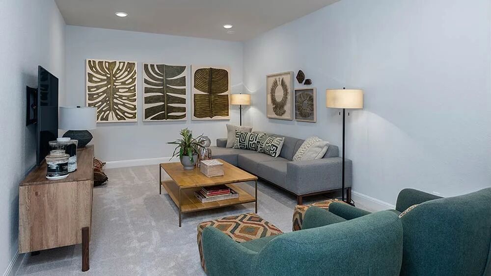 9104 The Ravine Way Austin, TX 78744 - Photo 18 of 29 a living room with furniture and a flat screen tv