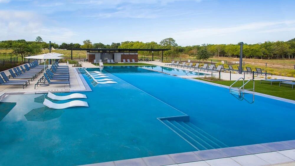 9104 The Ravine Way Austin, TX 78744 - Photo 25 of 29 a view of swimming pool with outdoor seating and lake view