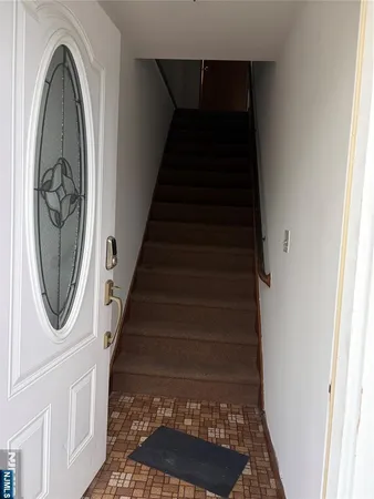 a view of a entryway with wooden floor and a window