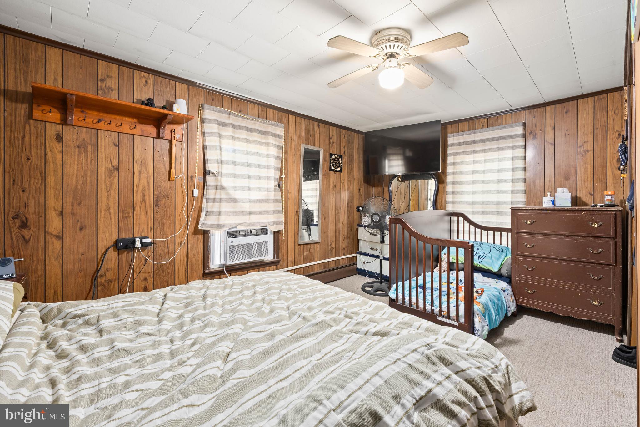 26467 Mariners Road Crisfield, MD 21817 - Photo 40 of 44 a bedroom with a bed and a chandelier