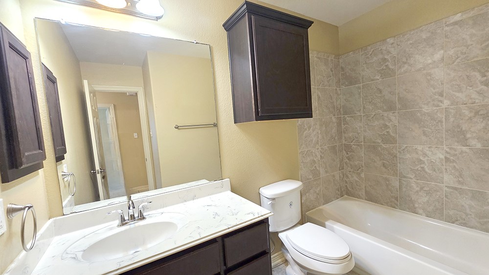 8031 Canyon Street Houston, TX 77051 - Photo 16 of 17 a bathroom with a sink a toilet and shower