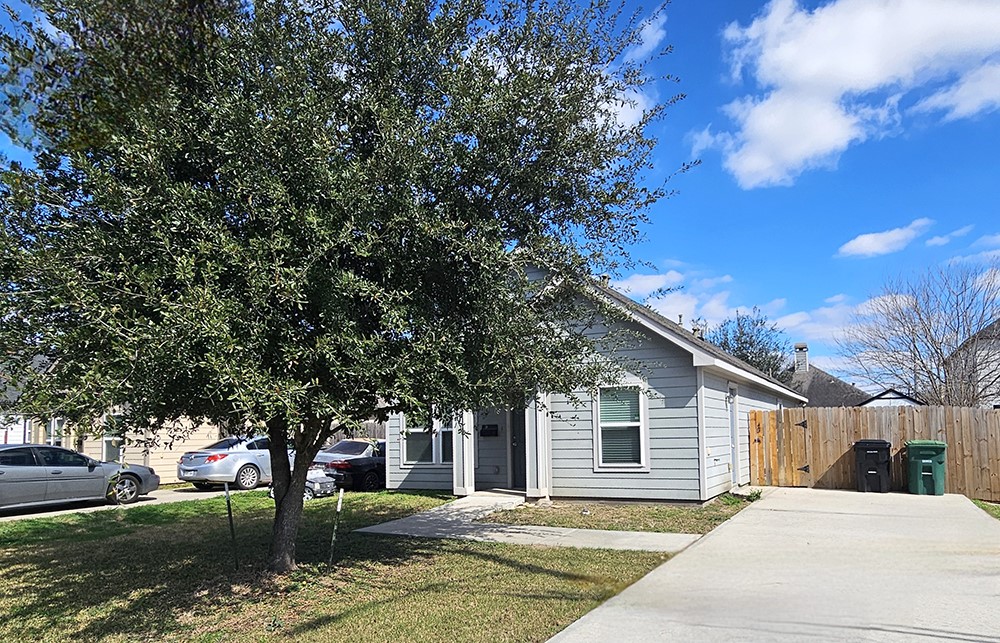 8031 Canyon Street Houston, TX 77051 - Photo 2 of 17 a house with trees in the background