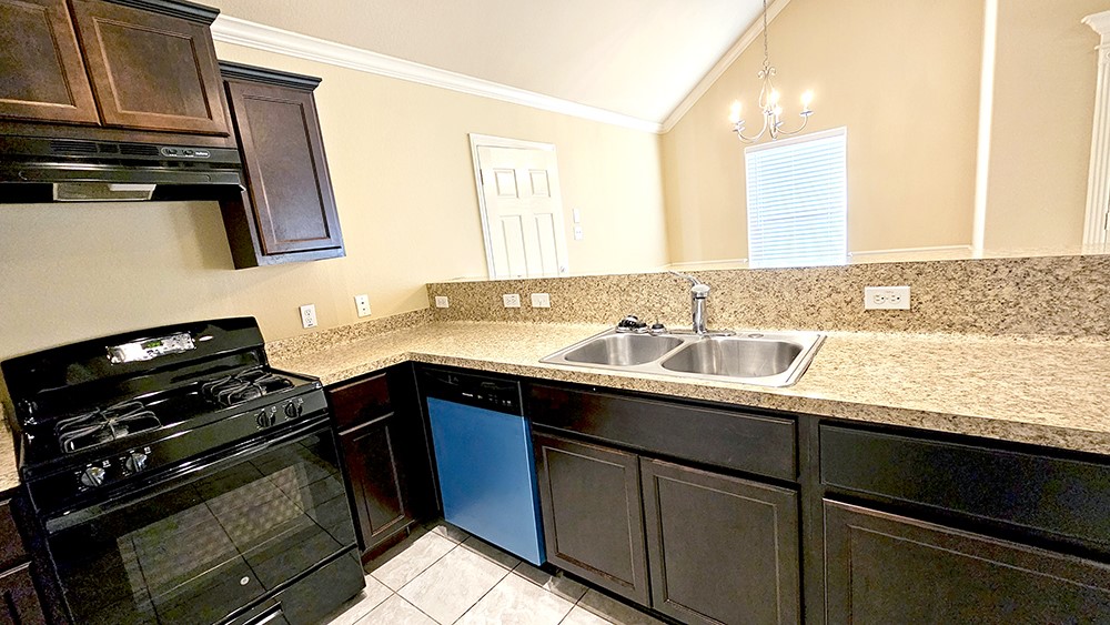 8031 Canyon Street Houston, TX 77051 - Photo 10 of 17 a kitchen with a sink a stove and cabinets