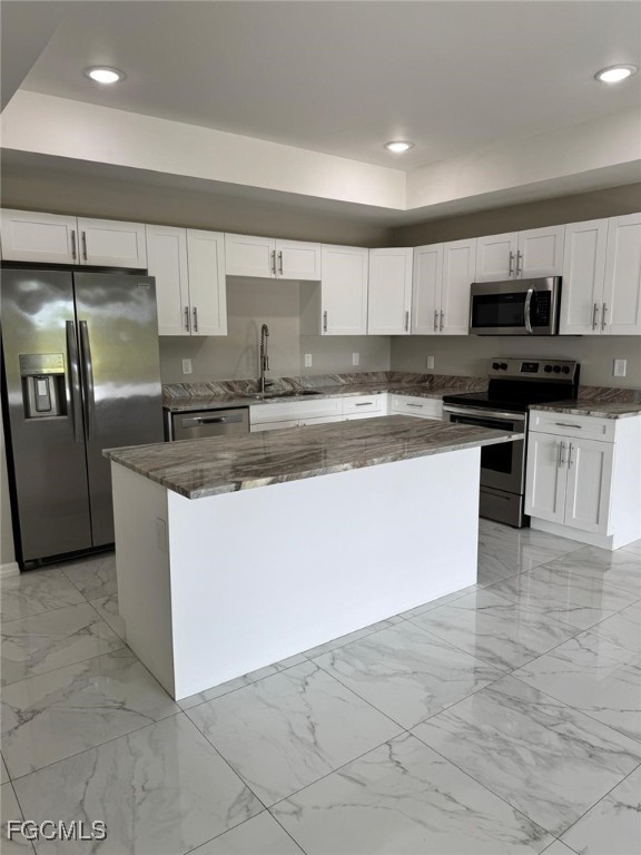 610 Alabama Road South Lehigh Acres, FL 33974 - Photo 2 of 12 a kitchen with stainless steel appliances granite countertop a sink a stove top oven a counter space and cabinets