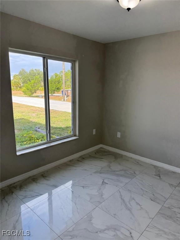 610 Alabama Road South Lehigh Acres, FL 33974 - Photo 5 of 12 a view of an empty room with a window