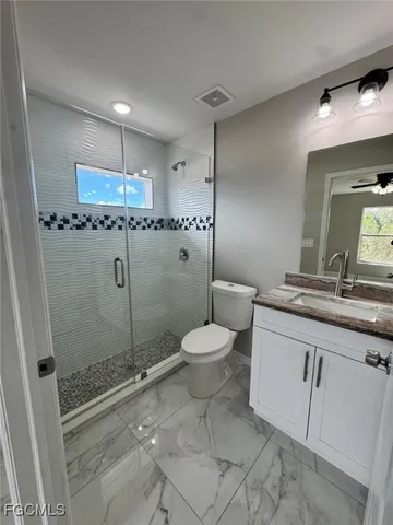 a bathroom with a toilet sink and shower