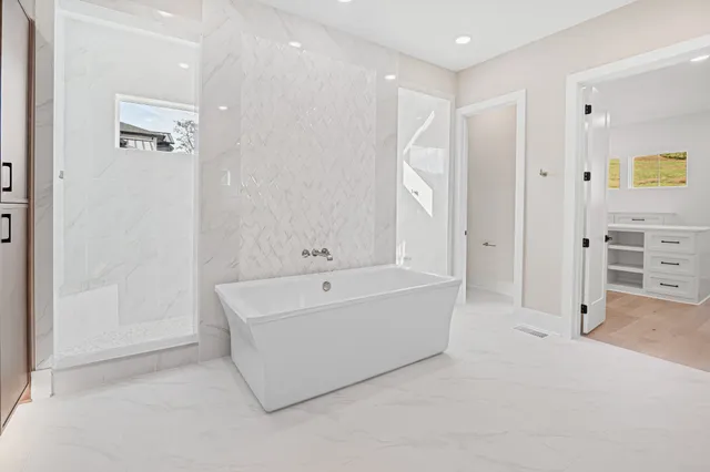 a bathroom with a tub shower and a sink