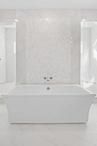 a bathroom with a bathtub and shower