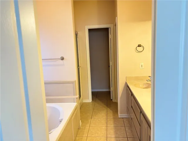 a bathroom with a tub and shower
