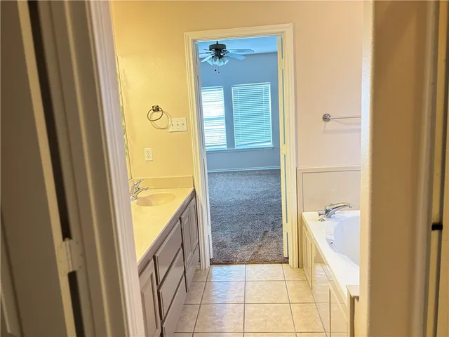 a bathroom with a tub shower and a sink