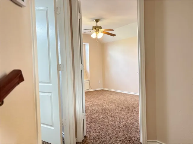 a view of a livingroom and a hallway