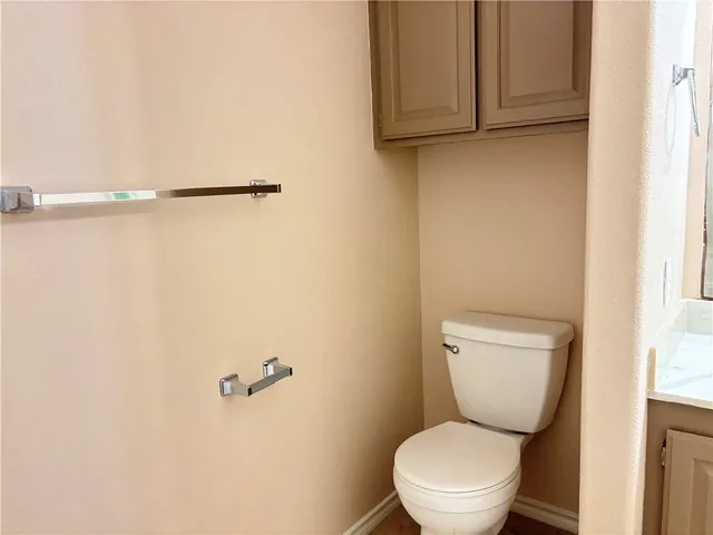 a white toilet sitting next to a shower