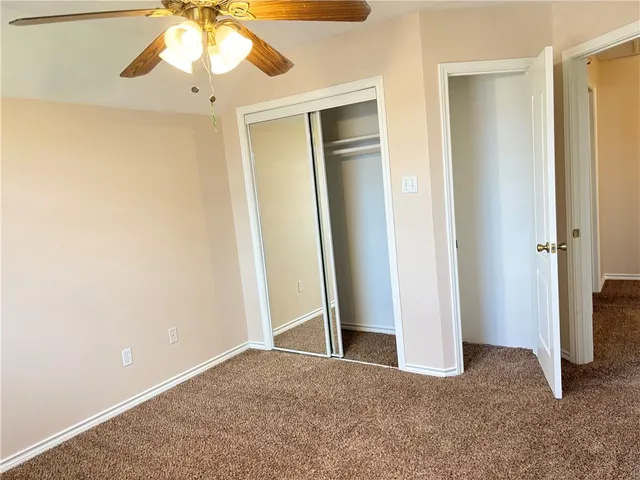 a view of an empty walk in closet with empty racks
