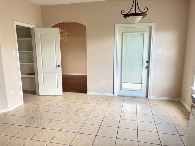 an empty room with closet and windows
