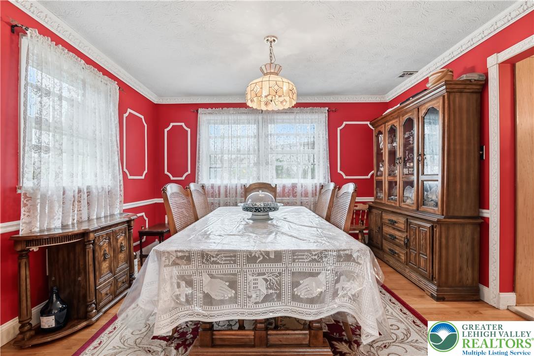 3303 Barklay Road Whitehall, PA 18052 - Photo 10 of 39 A formal dining room provides an elegant setting for meals with hardwood flooring and decorative crown molding.