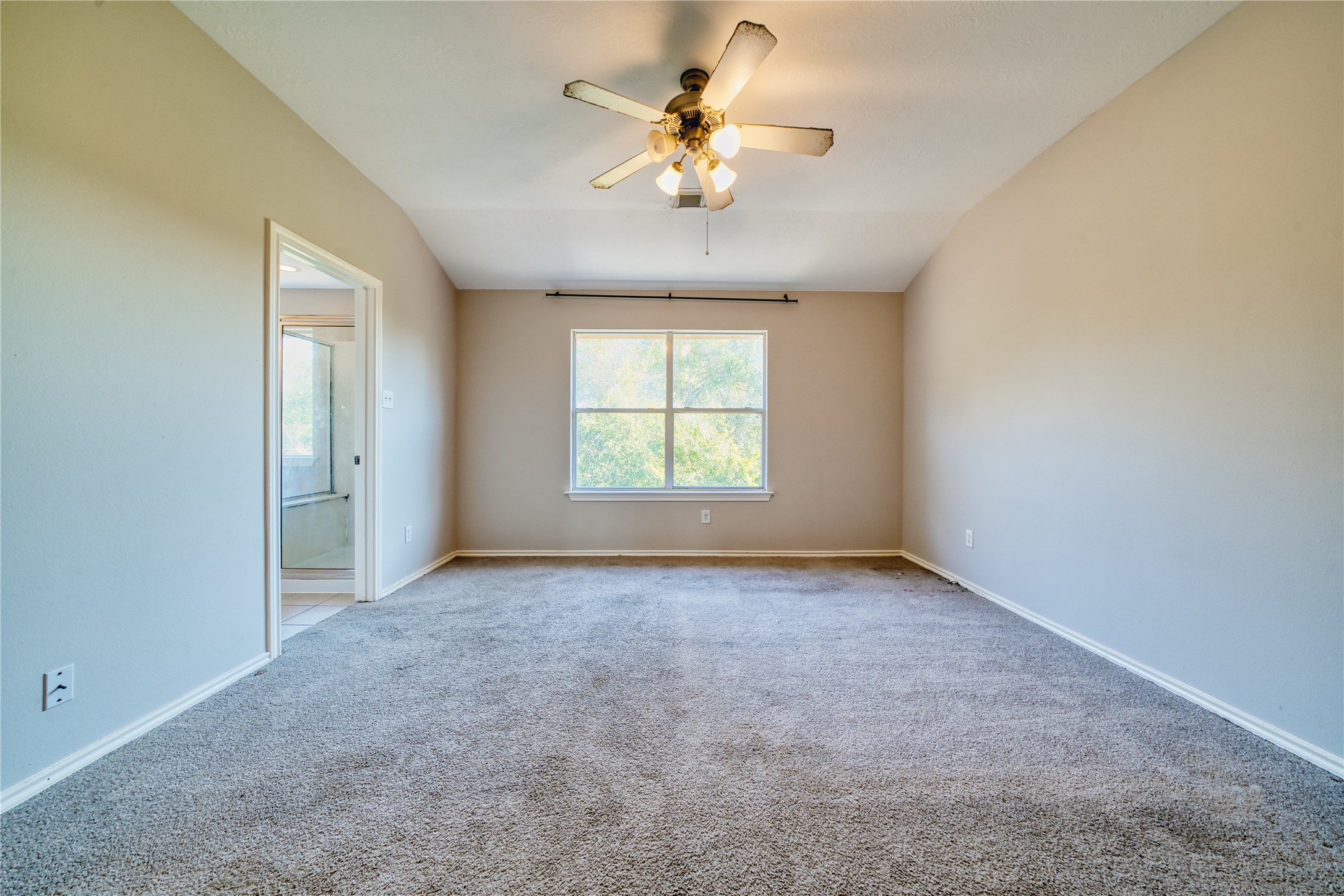 2907 Hackamore Houston, TX 77014 - Photo 24 of 33 an empty room with windows and chandelier fan