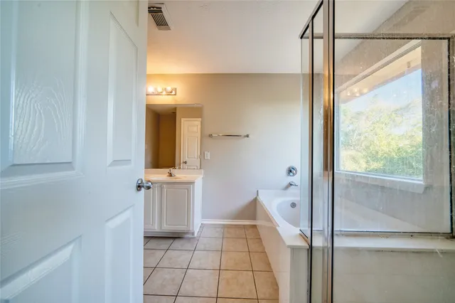 a bathroom with a double vanity sink and mirror