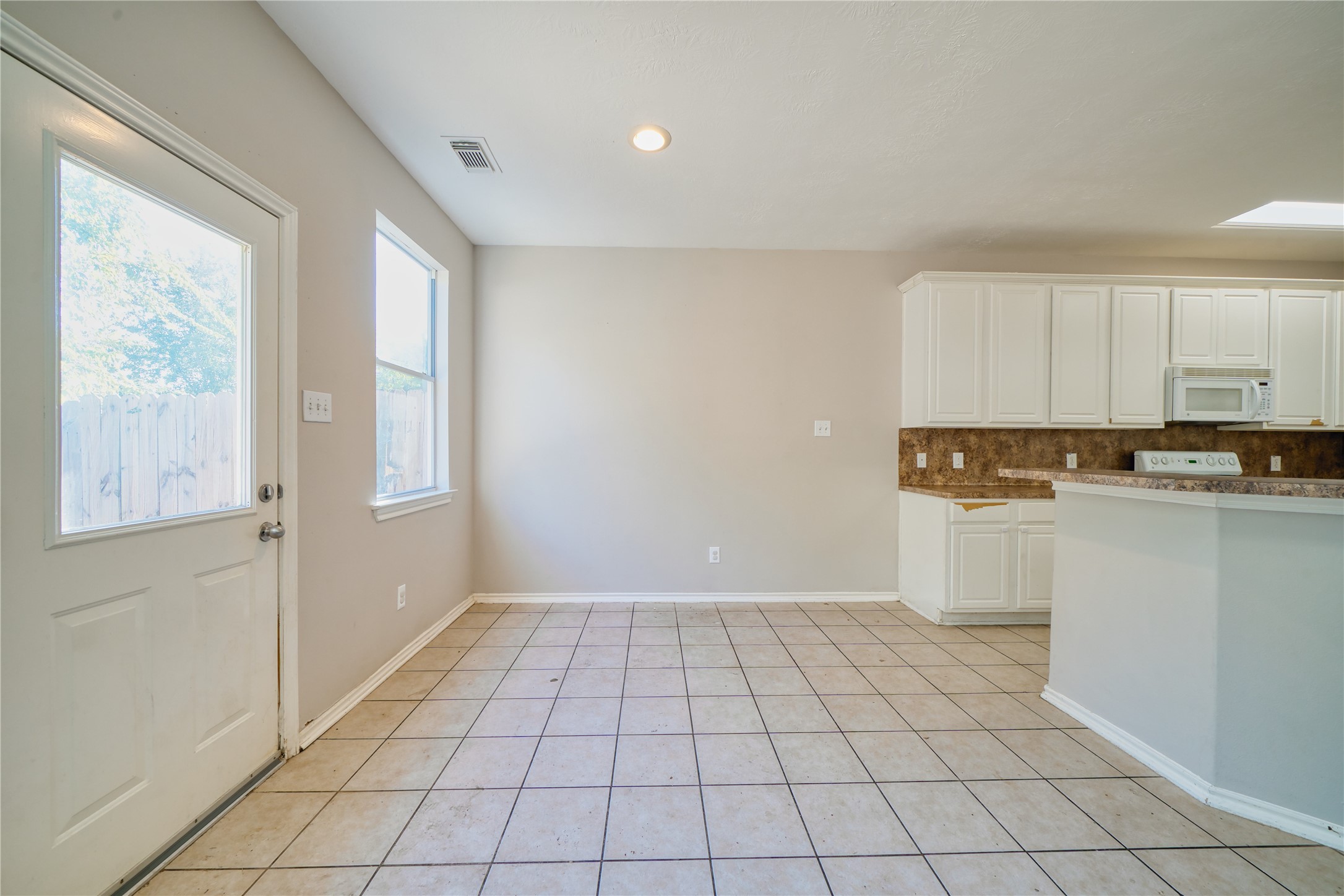2907 Hackamore Houston, TX 77014 - Photo 9 of 33 a view of a kitchen with white cabinets and wooden floor