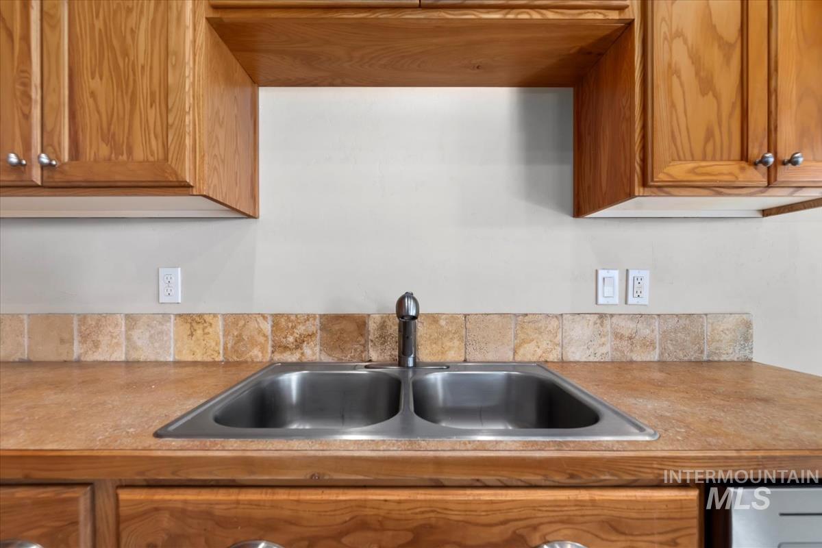 1838 Ridge Way Middleton, ID 83644 - Photo 19 of 42 Kitchen featuring brown cabinetry and light countertops