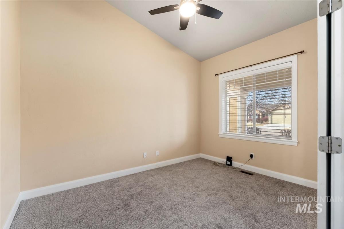 1838 Ridge Way Middleton, ID 83644 - Photo 21 of 42 Empty room with carpet flooring, lofted ceiling, and a ceiling fan