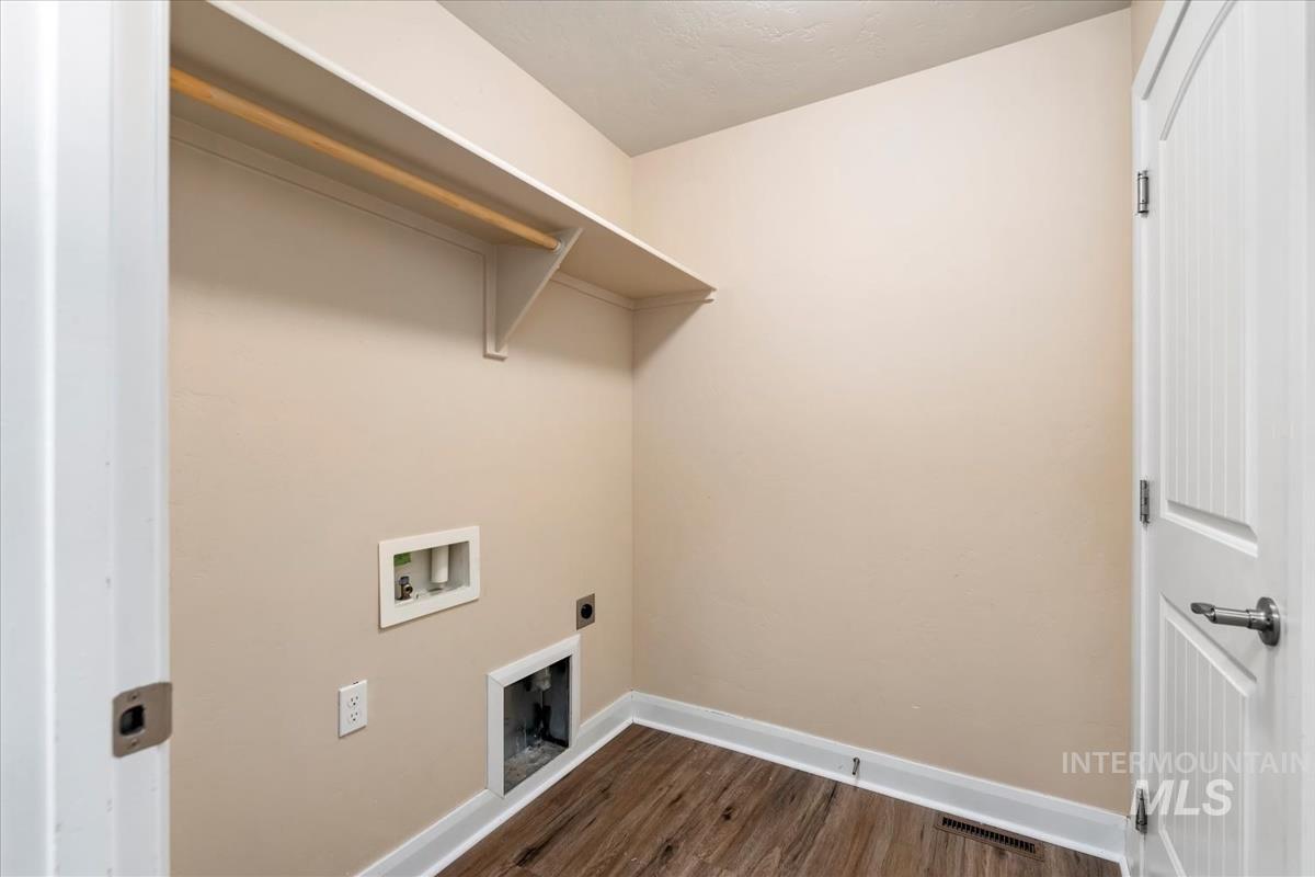 1838 Ridge Way Middleton, ID 83644 - Photo 22 of 42 Washroom featuring dark wood-style floors, hookup for an electric dryer, and hookup for a washing machine