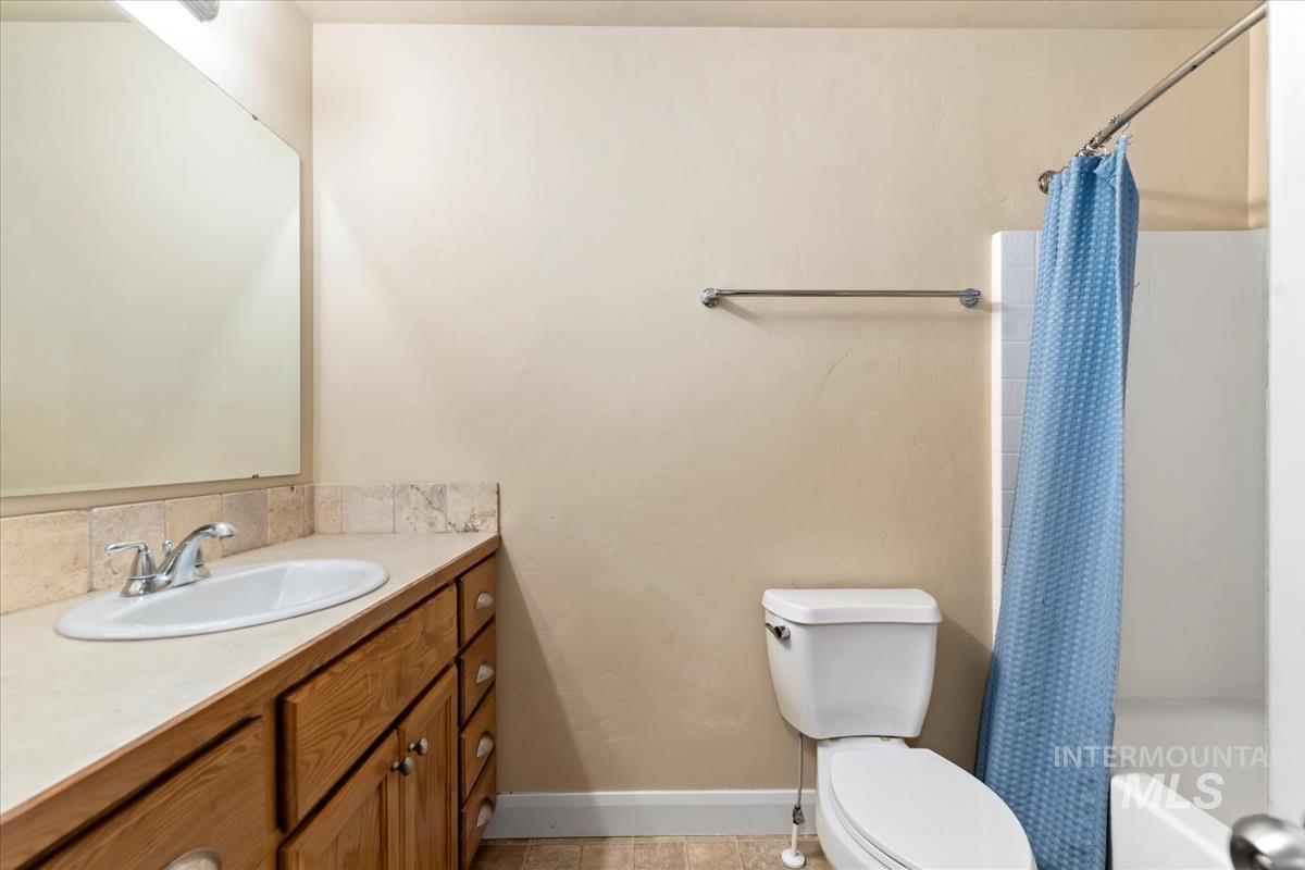1838 Ridge Way Middleton, ID 83644 - Photo 23 of 42 Full bathroom with vanity, shower / tub combo, and light tile patterned flooring